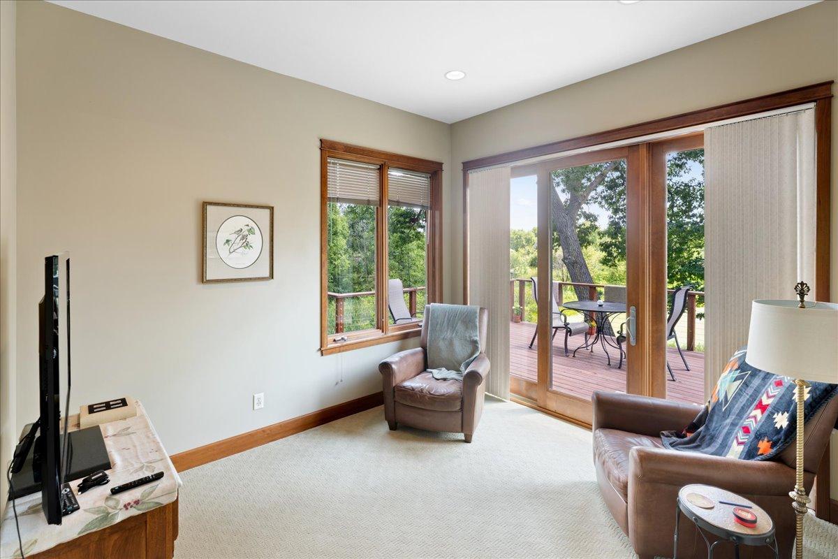Triple Marvin patio doors seamlessly connect the sunroom to the massive deck, inviting you to enjoy serene views of the surrounding wetlands, native wildlife, and the ever-changing beauty of nature just beyond.