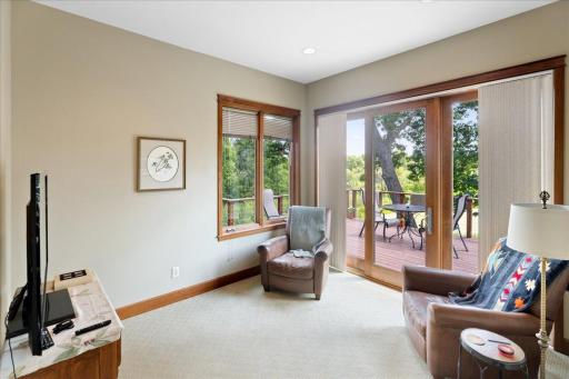 Triple Marvin patio doors seamlessly connect the sunroom to the massive deck, inviting you to enjoy serene views of the surrounding wetlands, native wildlife, and the ever-changing beauty of nature just beyond.