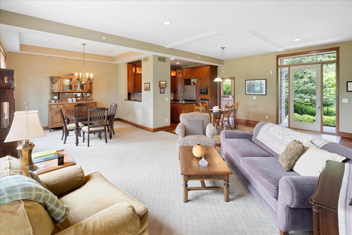 Elegant racetrack-style ceiling details subtly define each living space while preserving the home's open-concept design and uninterrupted sense of spaciousness.