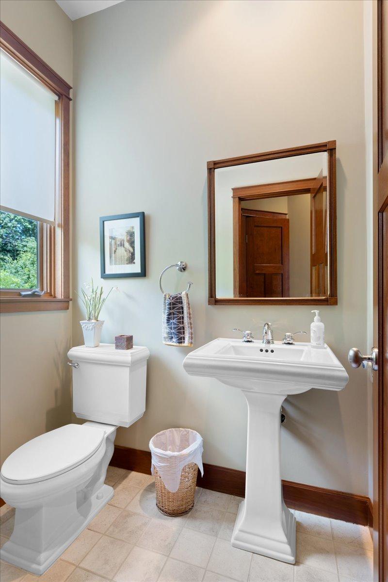 Conveniently positioned just off the main entry, the main-level powder room provides a stylish and welcoming touch for guests while complementing the home's well-designed flow.