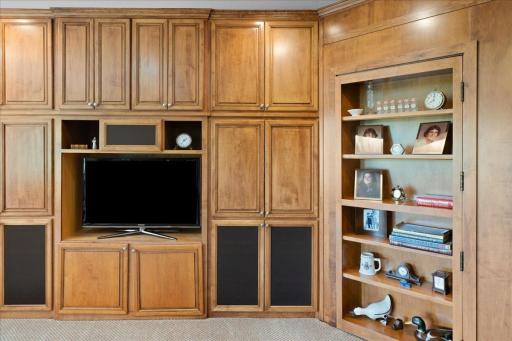 One of the home's more unique design features is the secret bookcase hidden door, a creative architectural element that blends seamlessly into the dÃ©cor while adding a touch of intrigue, personality, and functionality. See next photo with door open.