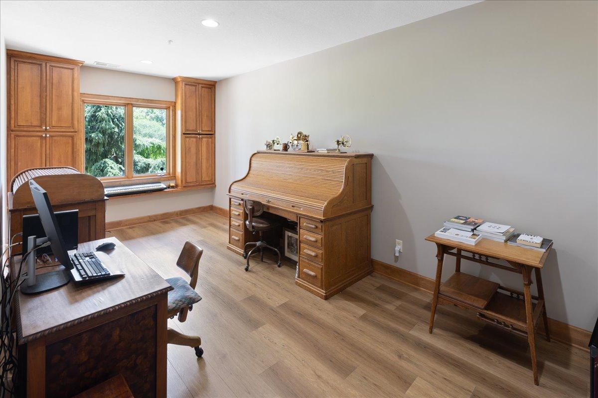 This spacious multi-purpose room, easily serving as a bedroom, craft or hobby area, home office, or fitness center. Luxury vinyl flooring and a sunny southern exposure create a bright, inviting environment that adapts toa variety of lifestyle needs.