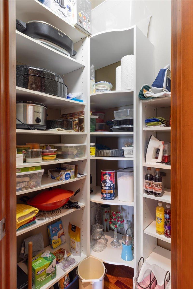 Additional storage is provided by the fully shelved pantry closet, offering exceptional organization and easy access to kitchen essentials.