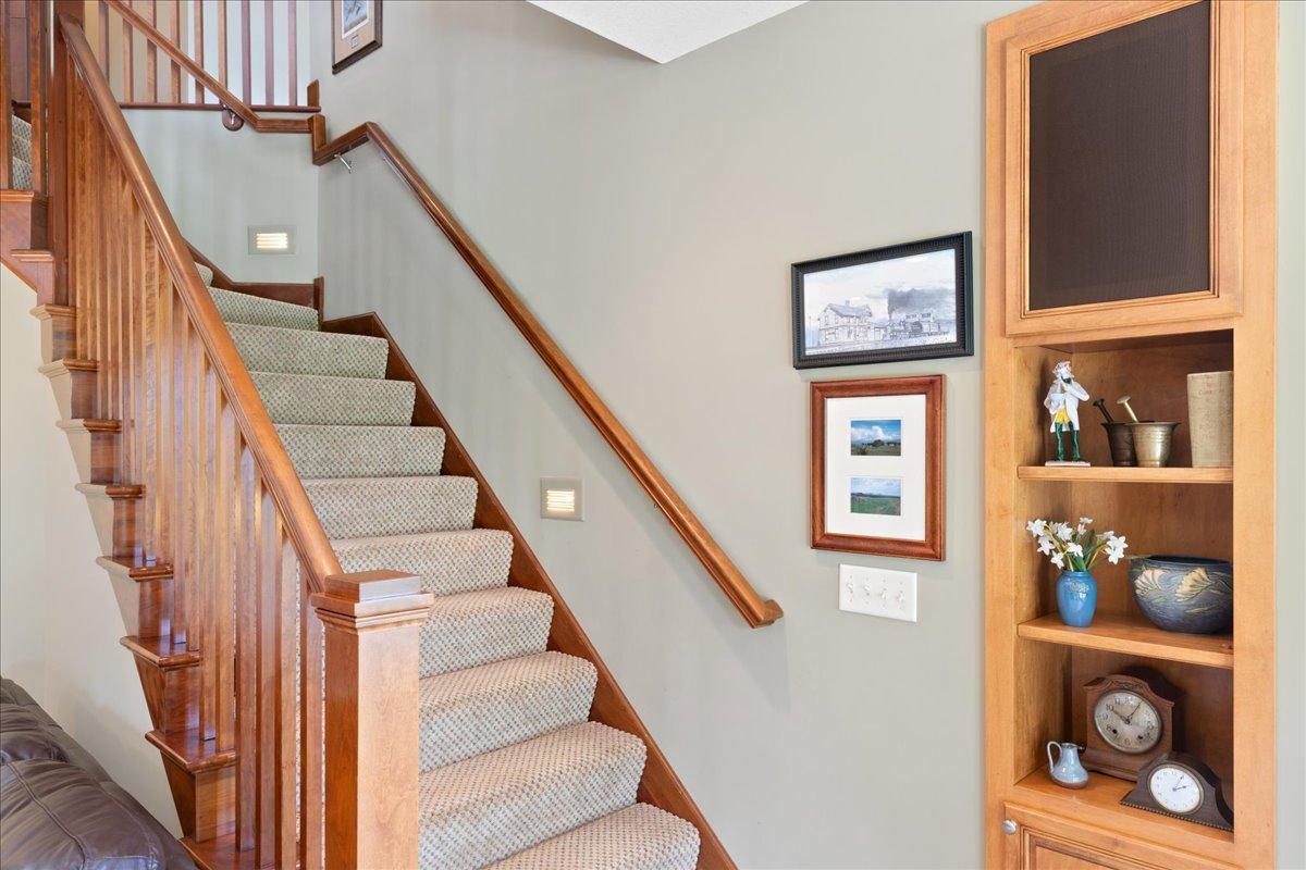 Carrying the home's open-concept design into the lower level, the thoughtfully designed open staircase visually connects both floors, creating a seamless transition and allowing the two levels to feel like one cohesive living space.