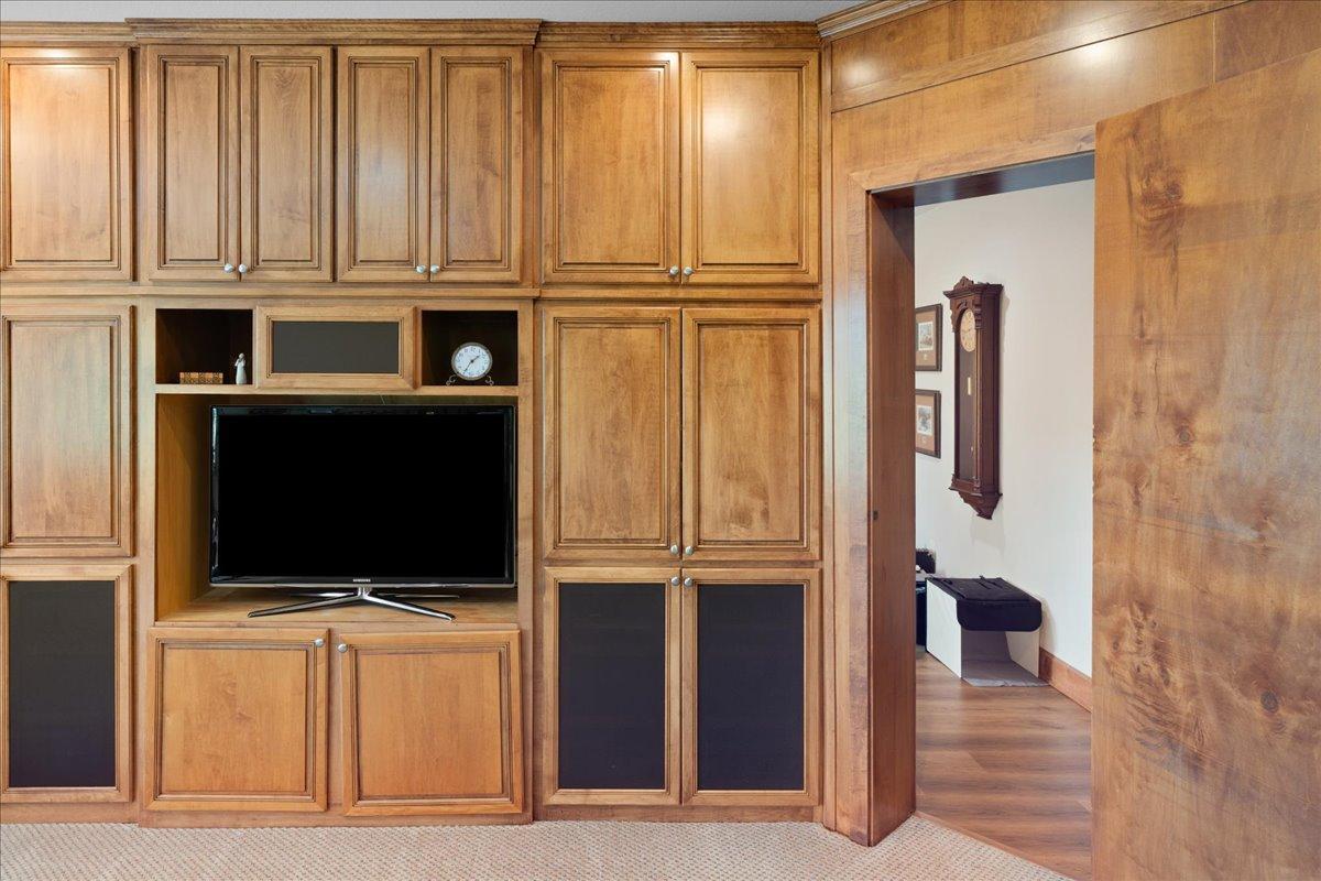 Behind the bookcase door lies another versatile and inviting space that can serve as an additional bedroom, flex room, or creative retreat for arts and crafts. This unique hidden room adds a unexpected element to the home's thoughtful design.