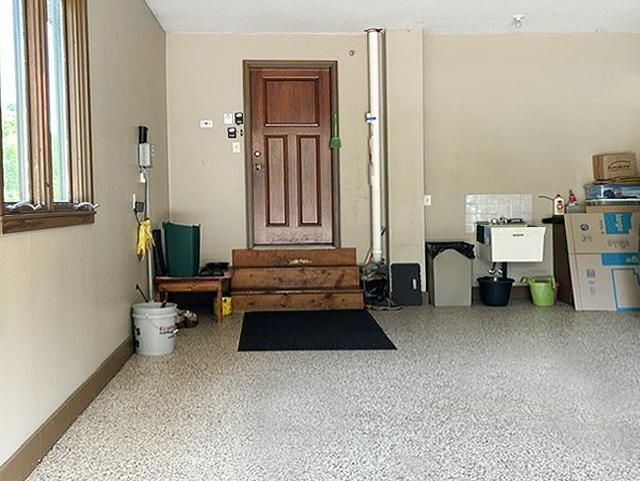 The oversized garage is finished as the rest of the home. Features include in-floor heated concrete slab, durable epoxy-coated floors, floor drains, abundant built-in storage, a workbench, creating a space that's as functional as it is impressive.