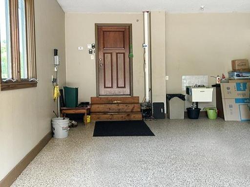 The oversized garage is finished as the rest of the home. Features include in-floor heated concrete slab, durable epoxy-coated floors, floor drains, abundant built-in storage, a workbench, creating a space that's as functional as it is impressive.