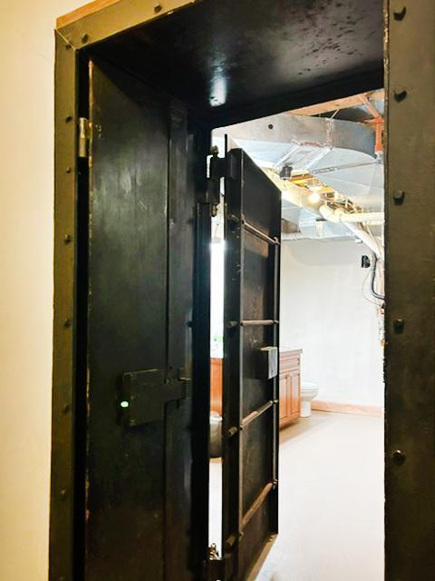 From inside the vault room, you can truly appreciate the massive steel-plated vault door. Its extraordinary thickness reflects the uncompromising security designed into this one-of-a-kind space.