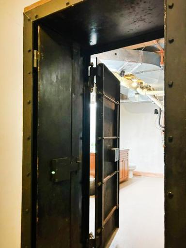From inside the vault room, you can truly appreciate the massive steel-plated vault door. Its extraordinary thickness reflects the uncompromising security designed into this one-of-a-kind space.
