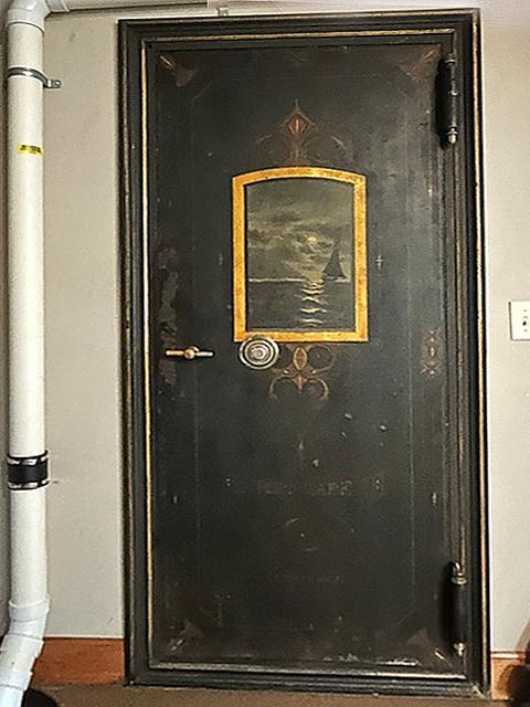Here's something unique- a true bank vault door built into the wall.