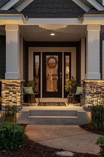 This front porch offers a stunning first impression day or night.