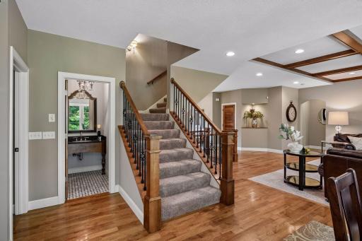 The powder room is ideally located for easy access from multiple main floor rooms and the wide stairway to the upper level.