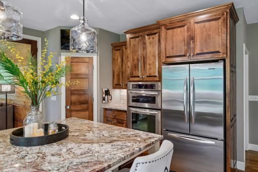 The kitchen is equipped with a convection wall oven, convection wall microwave, and built-in coffee maker.