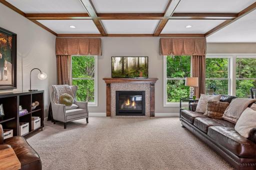 A gas fireplace with tile surround and wood mantle serves as the living roomâs inviting focal point.