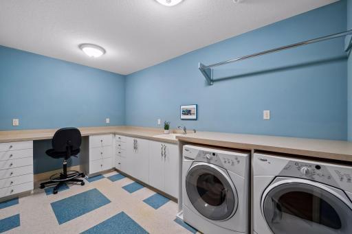 The upper-level laundry is spacious and includes plenty of counter and cabinet space.