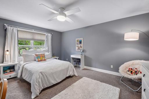 The second bedroom on the upper level also overlooks the backyard and has a ceiling fan.