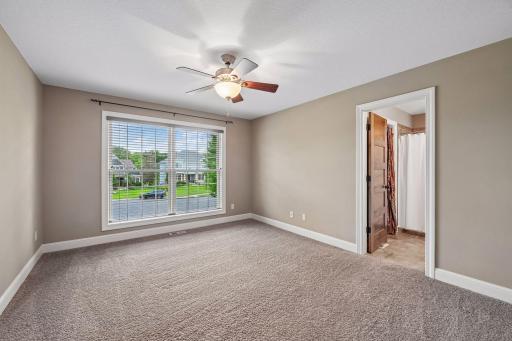 The third upper-level bedroom has a ceiling fan and an ensuite bath.