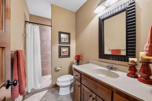 The lower level bathroom has a tile shower and tile flooring.