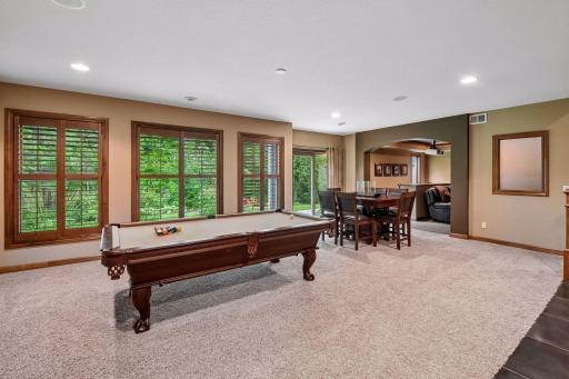 Large windows overlook the backyard and feature upscale plantation shutters.
