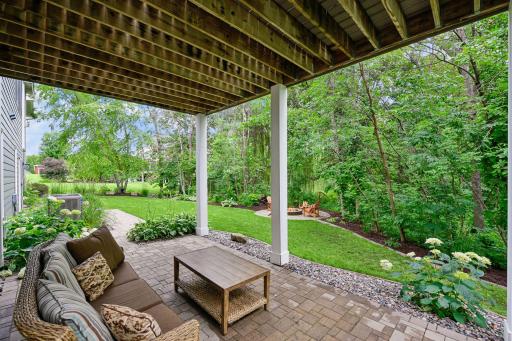 The under-deck patio creates a quiet, shaded space for seating.