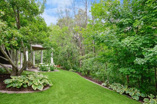 The lush, landscaped backyard offers complete privacy.