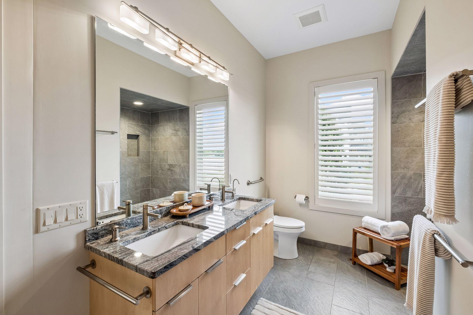 Start and end each day in a spa-inspired primary bath designed for comfort and ease. Dual vanities, upscale finishes and a beautiful zero-entry tile shower create a relaxing retreat where luxury meets everyday living by the lake.