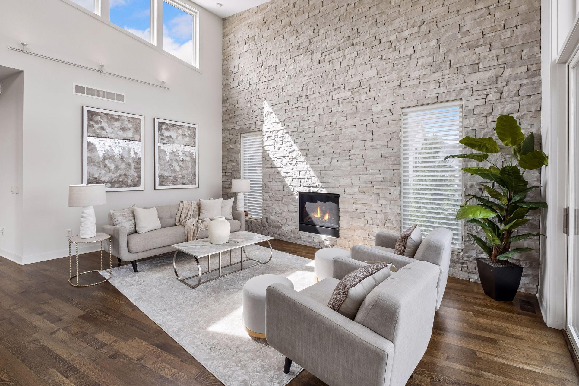 A true lakefront showpiece featuring a soaring floor-to-ceiling stacked stone accent wall, elegant fireplace and walls of windows that fill the great room w/natural light. An unforgettable setting for lakeside gatherings, relaxation and sunset views.