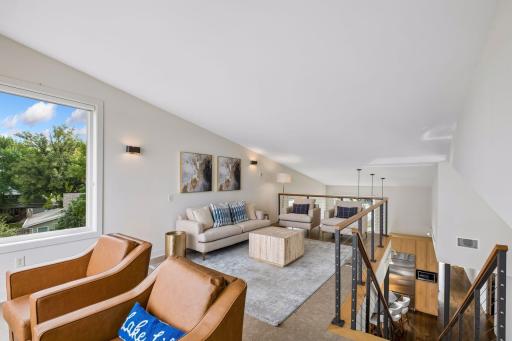 Perched above the water, this inviting loft offers a front-row seat to lake life at its finest. The perfect retreat for morning coffee, sunset conversations or a quiet escape, with breathtaking views. An open connection to the heart of the home below