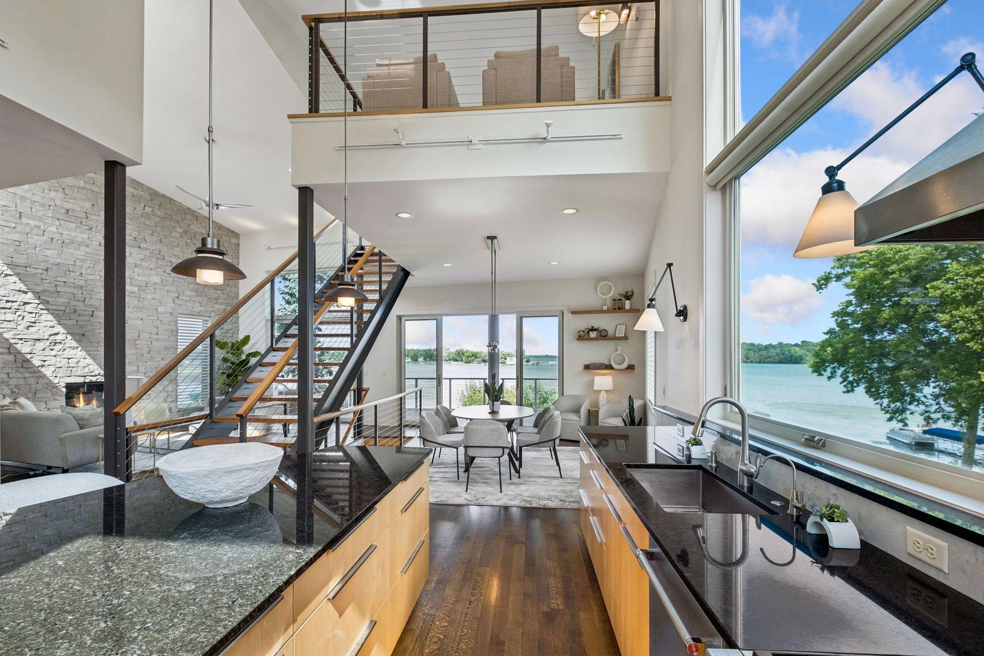 Experience lake living where stunning architecture frames every view. Soaring ceilings, dramatic open-riser staircase, walls of glass and sweeping lake vistas create a breathtaking backdrop for everyday living, entertaining an unforgettable memories.