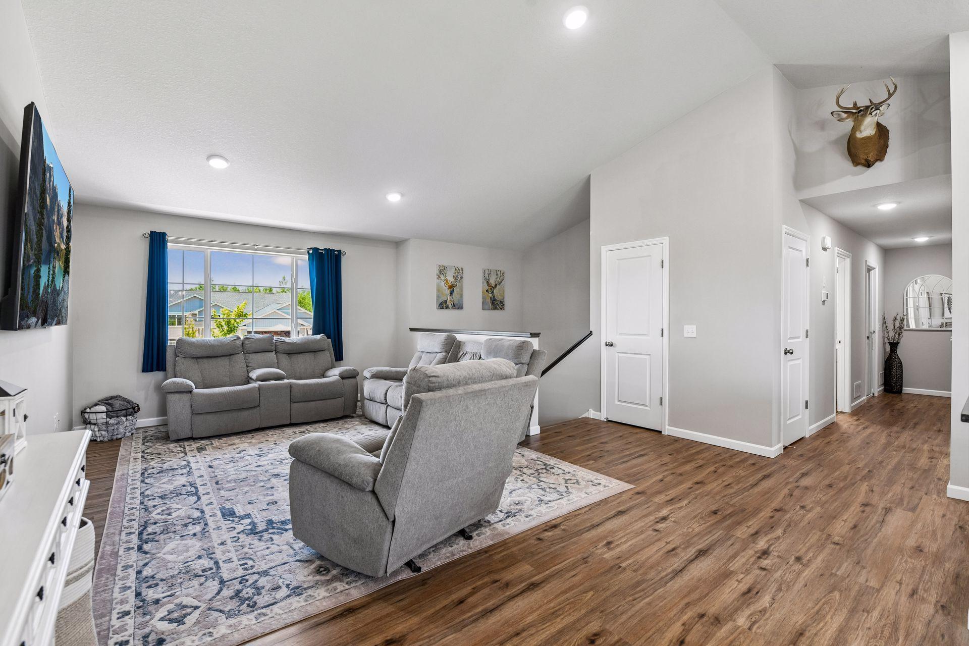 View from kitchen table showing open flow with wide hallways and LVP flooring.