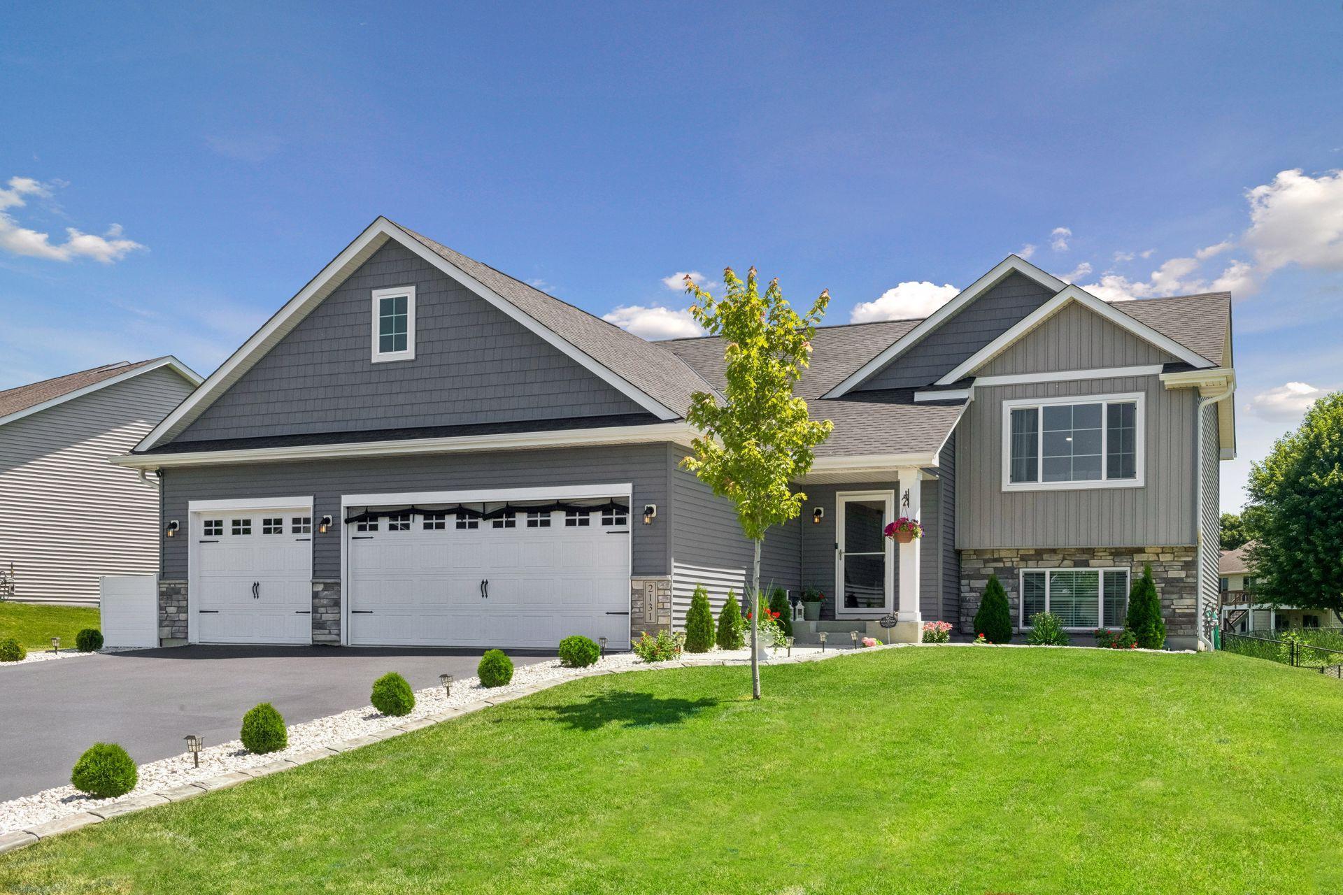 Stunning curb appeal new landscaping and Borderwerx concrete edging w/white rock accents.