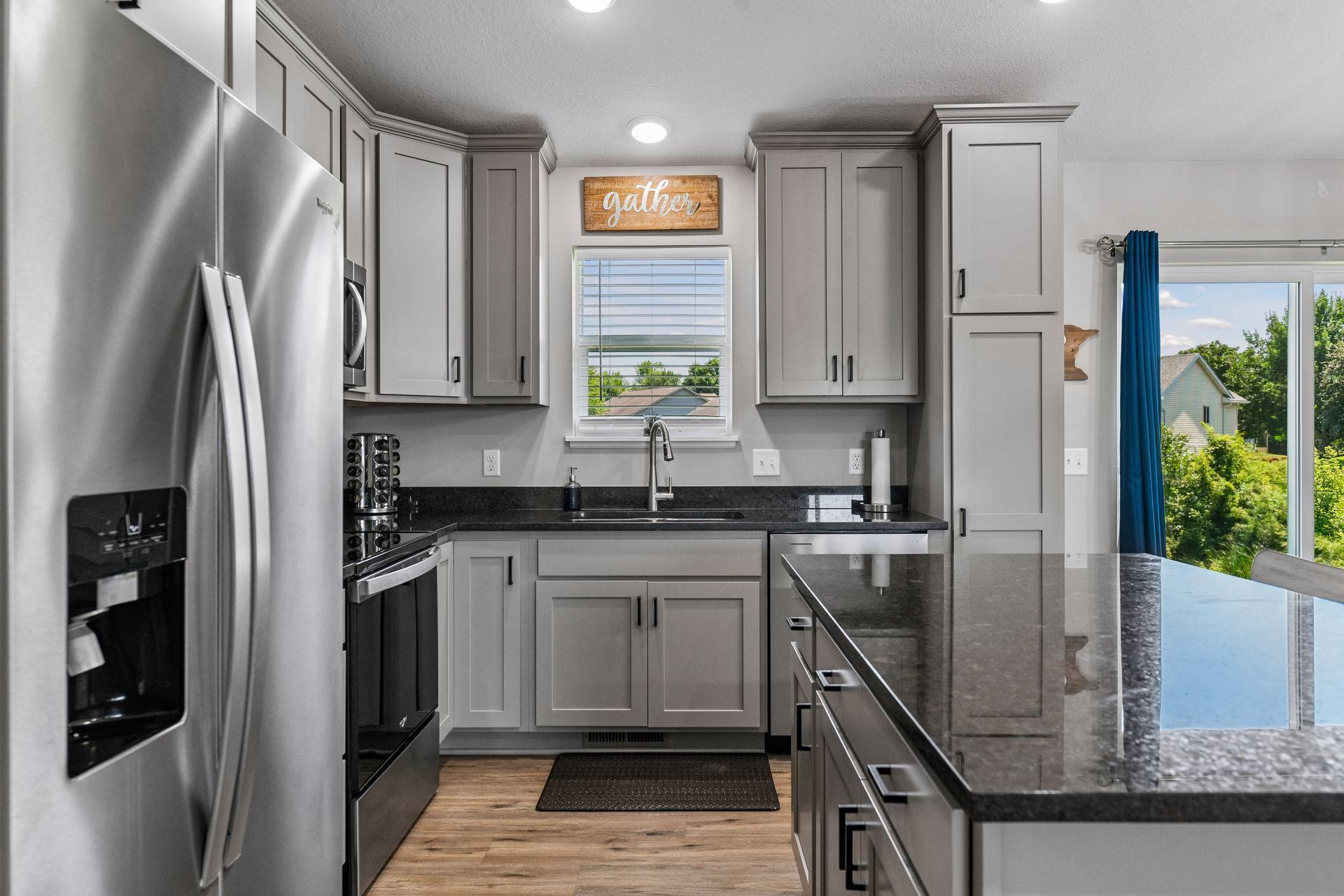 Stainless steel appliances with lots of cupboard space along with island storage.