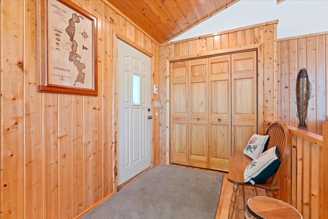 A spacious entryway features a double-wide closet and room for added seating and storage.