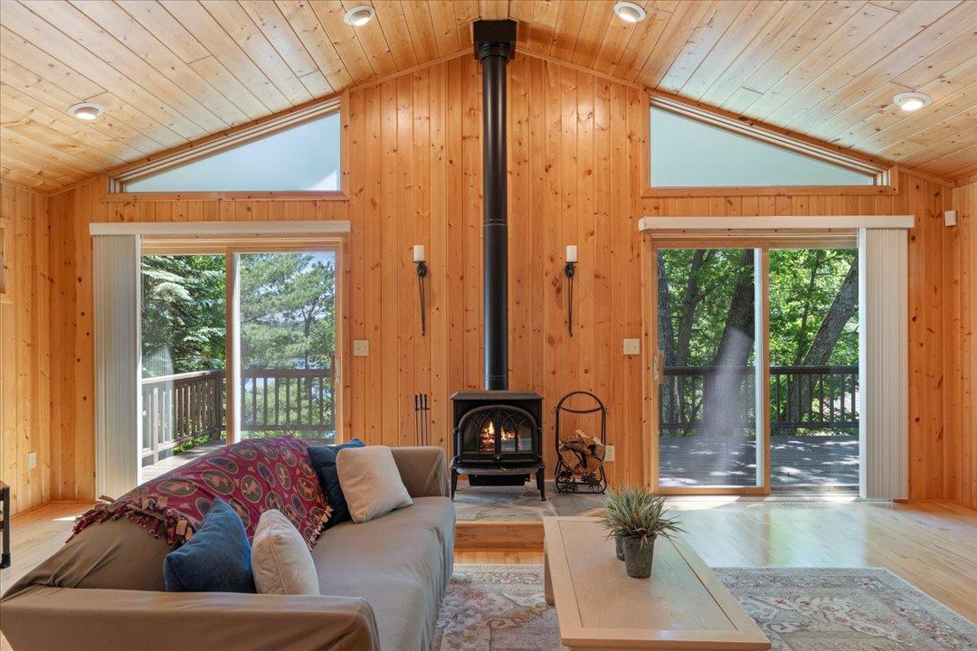 Double sliding glass doors flood the living area with natural light and open directly to the deck, blending indoor comfort with the beauty of the outdoors