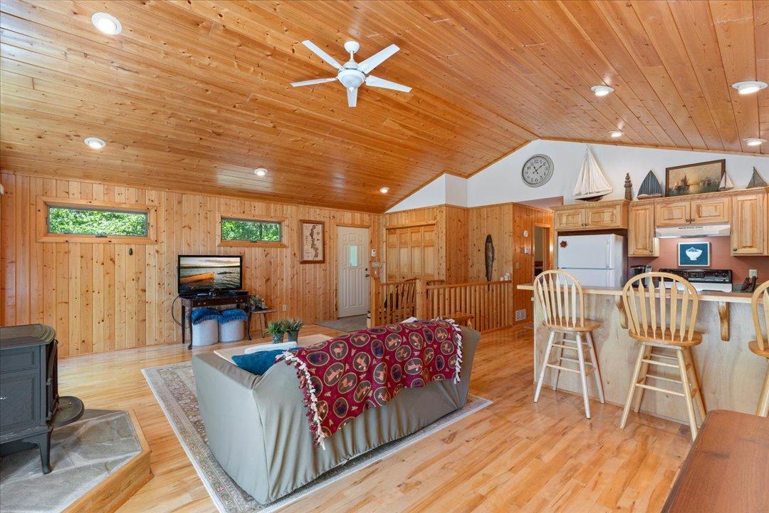 Featuring gorgeous hardwood floors and rich wood-paneled ceilings, this space captures the warmth and character of a classic lake retreat