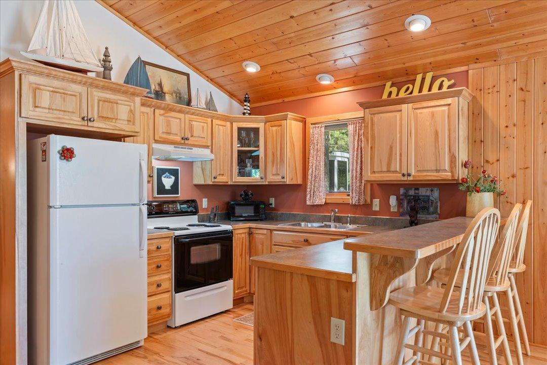 The thoughtfully designed kitchen offers counter seating, a bright window above the sink, and a welcoming layout perfect for everyday living