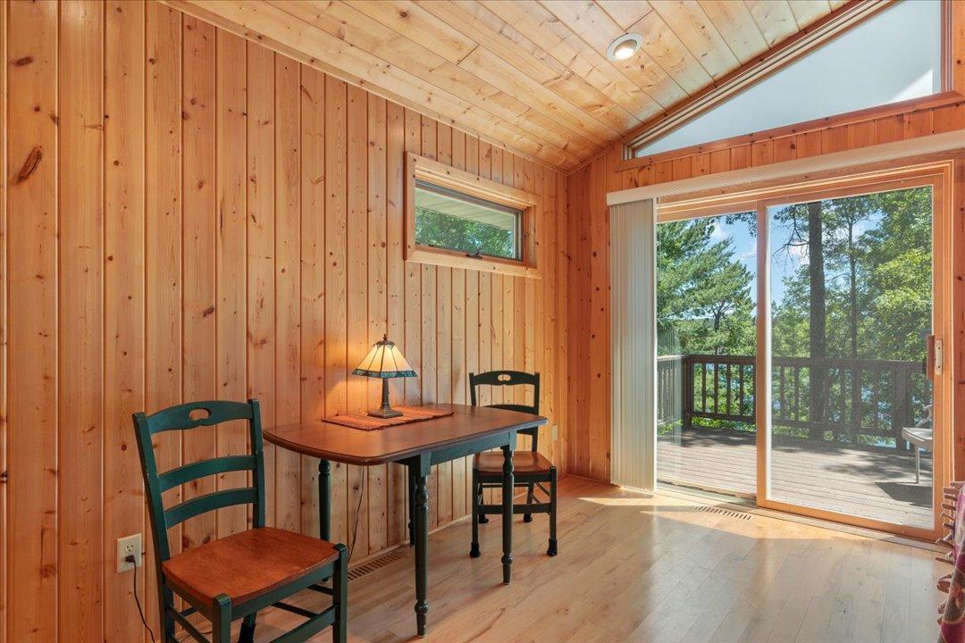 The informal dining area flows effortlessly to the deck, ideal for outdoor dining and grilling