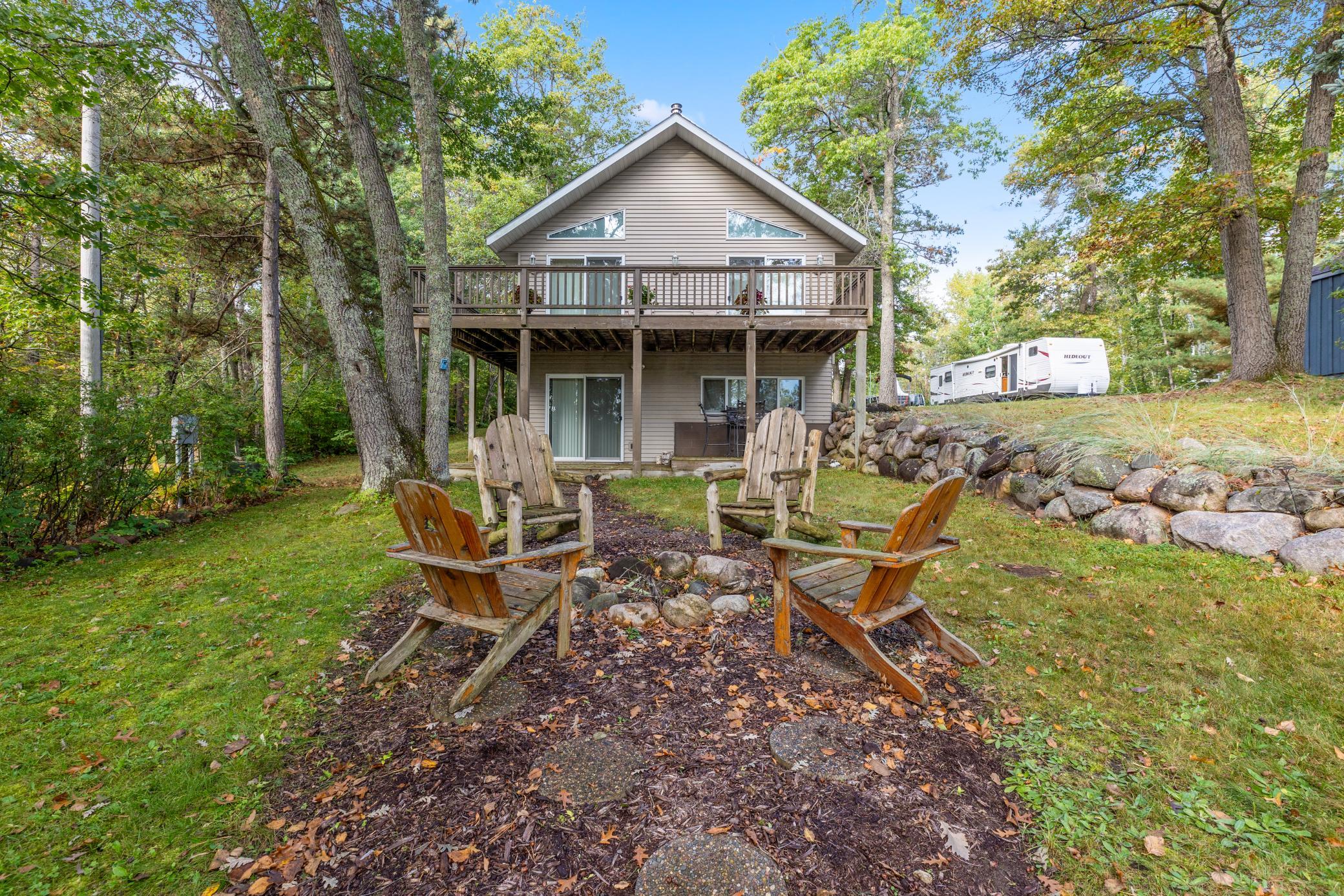 Sit around the backyard firepit under the trees