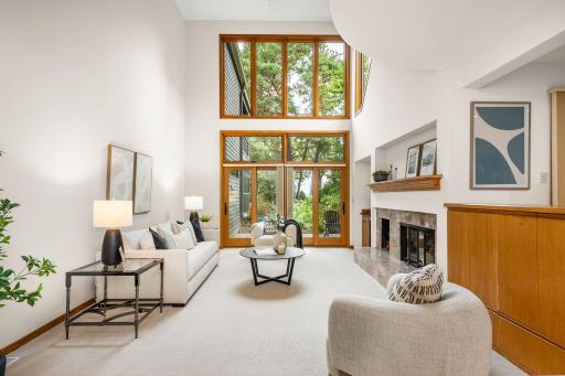 Great Room gatherings seamlessly flow onto the lakeside patio through wood framed sliding doors.