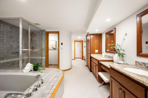 The primary bath includes a private water closet, walk in shower, and jacuzzi tub