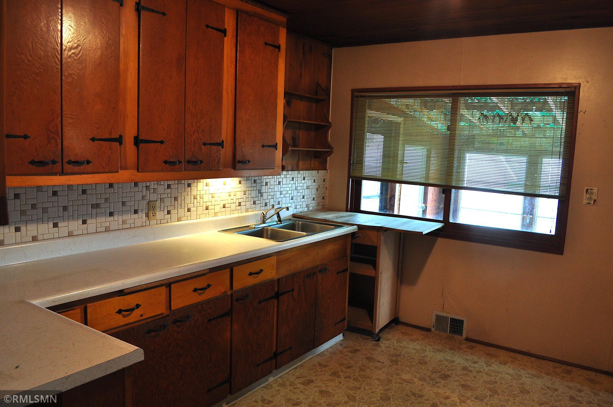 Kitchen window overlooking screened-in porch
