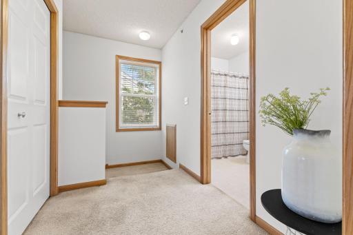 The upper-level landing creates a natural transition between the home’s private spaces.