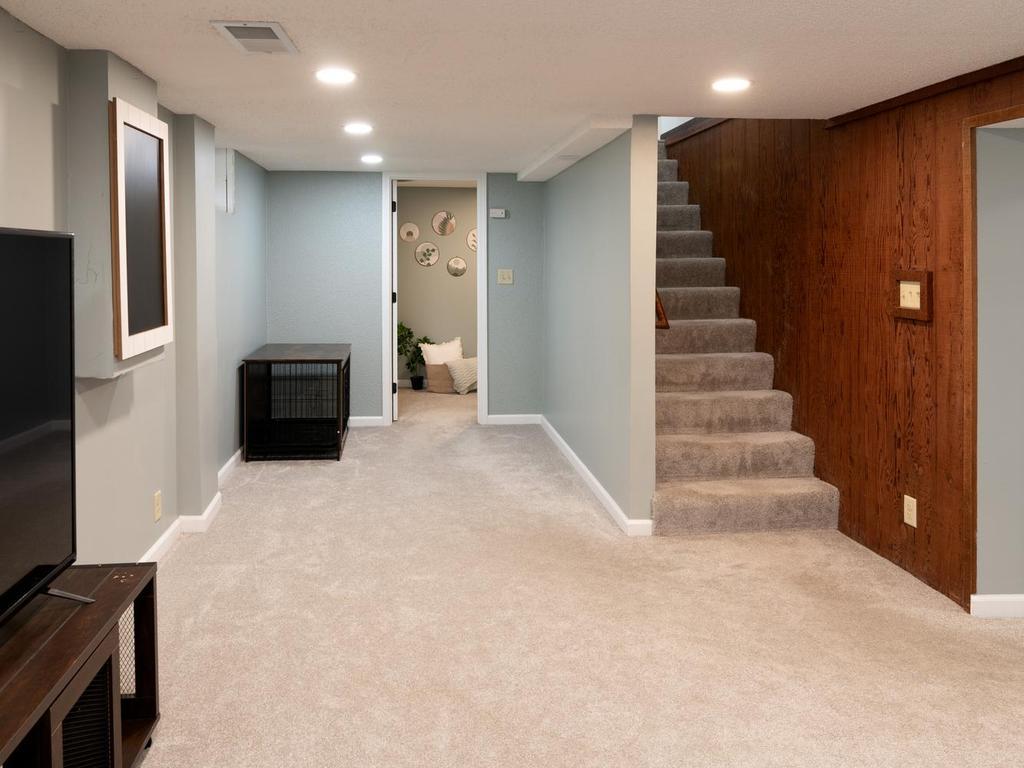Finished lower level with a cozy family room at the base of the stairs