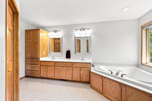 Spacious primary bath with oversized vanity, soaking tub, and custom built-ins. 61. Primary Shower