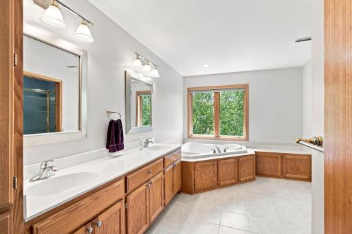 Spacious primary bath with oversized vanity, soaking tub, and custom built-ins. 61. Primary Shower
