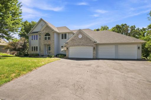 Oversized heated and insulated 4-car garage provides abundant space for vehicles, storage, workshop space, or hobbies. The wide driveway and beautifully maintained exterior create impressive curb appeal while showcasing the home's executive design.