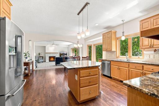 Large kitchen window overlooks the private wooded backyard.