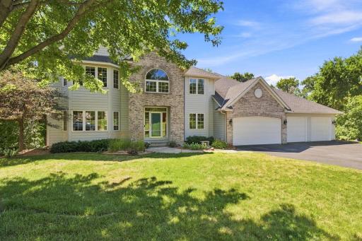 Executive two-story in Lakeville offering timeless curb appeal with brick and maintenance-free exterior, mature trees, and an oversized heated 4-car garage. Located on a private wooded lot in one of Lakeville's most sought-after neighborhoods, this h