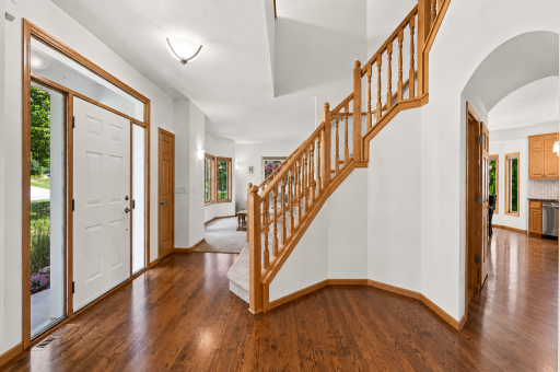Grand two-story foyer welcomes you into this custom-built MacDonald home with rich hardwood floors, solid oak staircase, soaring ceilings, and timeless craftsmanship. An impressive first impression that immediately showcases the quality and thoughtfu