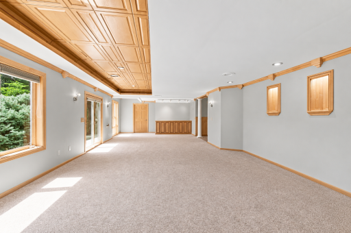 Virtually staged media room highlights the spacious layout and custom finishes.